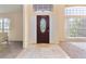 Inviting entryway features a decorative glass door, tile flooring, and large windows for natural light at 1154 Feather Dr, Deltona, FL 32725