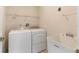 Functional laundry area featuring a washer, dryer, utility sink, and overhead shelving for organized storage at 1154 Feather Dr, Deltona, FL 32725