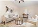 Cozy living room featuring a neutral color palette, comfortable seating, and an elegant glass-top coffee table at 1154 Feather Dr, Deltona, FL 32725