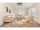 Bright living room with a large arched window, neutral decor, and comfortable seating arrangement at 1154 Feather Dr, Deltona, FL 32725