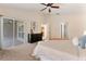 Spacious main bedroom featuring a ceiling fan, dresser, and sliding glass doors to the lanai at 1154 Feather Dr, Deltona, FL 32725