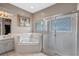 The bathroom features a soaking tub, vanity with sink, and glass-enclosed shower at 1225 Hollow Pine Dr, Oviedo, FL 32765
