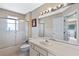 Bathroom features a shower/tub combo with sliding glass doors, toilet, and vanity with mirror at 1225 Hollow Pine Dr, Oviedo, FL 32765