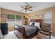 This bedroom features a dark wood sleigh bed, windows with blinds, and warm tan walls at 1225 Hollow Pine Dr, Oviedo, FL 32765