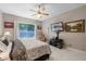 This bedroom features a ceiling fan, a flatscreen television, and access to the backyard at 1225 Hollow Pine Dr, Oviedo, FL 32765