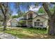 Attractive home with a two-car garage, lush landscaping, and arched windows that enhance curb appeal at 1225 Hollow Pine Dr, Oviedo, FL 32765