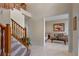 Elegant foyer with a staircase leading to the second floor and a view into a cozy living room, welcoming guests at 1225 Hollow Pine Dr, Oviedo, FL 32765
