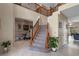 Grand foyer with a staircase, marble flooring, and ample natural light, creating an inviting first impression at 1225 Hollow Pine Dr, Oviedo, FL 32765