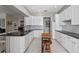 Bright kitchen with white cabinetry, black countertops, stainless steel appliances, and tile flooring at 1225 Hollow Pine Dr, Oviedo, FL 32765
