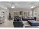 Bright living room with two ceiling fans, comfortable seating, and open layout with kitchen view at 1225 Hollow Pine Dr, Oviedo, FL 32765