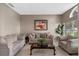 Cozy living room with comfortable seating, an elegant coffee table, and an artful arrangement creating a relaxing ambiance at 1225 Hollow Pine Dr, Oviedo, FL 32765