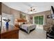 Tranquil main bedroom with a sliding glass door to the lanai, ceiling fan, and neutral decor at 1225 Hollow Pine Dr, Oviedo, FL 32765