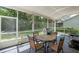 This screened in patio features a patio table, four chairs, and a stainless steel gas grill at 1225 Hollow Pine Dr, Oviedo, FL 32765
