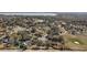 Aerial view of neighborhood homes and lake with golf course at 12419 Eryn Ct, Clermont, FL 34711