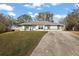 Charming single-story home featuring a well-manicured lawn and a concrete driveway on a sunny day at 12419 Eryn Ct, Clermont, FL 34711