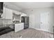 Modern kitchen with white cabinets, granite countertops, stainless steel appliances, and wood-look flooring at 12419 Eryn Ct, Clermont, FL 34711
