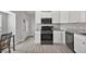 Well-lit eat-in kitchen with white cabinets, granite countertops, stainless steel appliances, and modern fixtures at 12419 Eryn Ct, Clermont, FL 34711