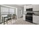 Bright kitchen area with table, stainless steel appliances, and white cabinets at 12419 Eryn Ct, Clermont, FL 34711