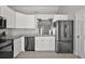 Contemporary kitchen boasting white cabinetry, granite countertops and sleek, stainless steel appliances at 12419 Eryn Ct, Clermont, FL 34711