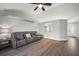 Inviting living room featuring light wood floors, modern ceiling fan, and a comfortable couch at 12419 Eryn Ct, Clermont, FL 34711