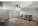 Bright living room with wood floors, a plush couch, and views of the outdoor space at 12419 Eryn Ct, Clermont, FL 34711