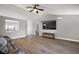 Bright living room featuring wood floors, a couch, and a mounted television at 12419 Eryn Ct, Clermont, FL 34711