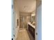 Bathroom featuring double doors, tiled floors, large counter with vanity, and tiled walk-in shower at 1259 Pando Loop, Orlando, FL 32824