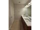 Bathroom featuring a double sink vanity with tile flooring and a door to the left at 1259 Pando Loop, Orlando, FL 32824