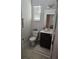 Cozy bathroom features a toilet, vanity with sink, and a framed mirror at 1259 Pando Loop, Orlando, FL 32824