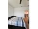 Bedroom with modern bed, staircase view, and neutral carpet flooring at 1259 Pando Loop, Orlando, FL 32824