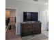 Bedroom with a TV on top of a brown dresser and view of the staircase at 1259 Pando Loop, Orlando, FL 32824