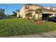 Well maintained two-story home featuring a lush green lawn and manicured landscaping at 1259 Pando Loop, Orlando, FL 32824