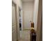 Hallway features tile flooring, leading to a laundry area and offering ample storage space at 1259 Pando Loop, Orlando, FL 32824