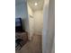 Hallway with carpeted floor, leading to closet storage, and other rooms of the home at 1259 Pando Loop, Orlando, FL 32824