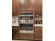 Modern kitchen featuring built in oven, dark wood cabinets and white countertops at 1259 Pando Loop, Orlando, FL 32824