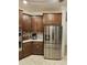 Gourmet kitchen featuring stainless steel appliances, dark wood cabinets, and sleek countertops at 1259 Pando Loop, Orlando, FL 32824
