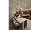 Stylish kitchen features a quartz island with pendant lighting and modern appliances at 1259 Pando Loop, Orlando, FL 32824
