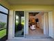 Screened-in lanai with a view of the backyard and living area at 1259 Pando Loop, Orlando, FL 32824