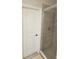 Bathroom shower with glass doors, tiled walls, and a white door at 1259 Pando Loop, Orlando, FL 32824