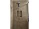 Shower showcasing tile walls, a shower head with an adjustable spray, and a recessed shelf at 1259 Pando Loop, Orlando, FL 32824