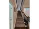 Carpeted stairway with decorative iron railing leading to the upper level of the home at 1259 Pando Loop, Orlando, FL 32824