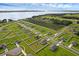 A high angle view of a neighborhood with well-maintained lawns and lake views at 12835 Del Lago Dr, Astatula, FL 34705