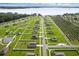 A distant aerial view shows a residential neighborhood, near a lake, and surrounded by an orchard at 12835 Del Lago Dr, Astatula, FL 34705