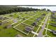 Expansive aerial view of a new residential community with green lawns and lake in the background at 12835 Del Lago Dr, Astatula, FL 34705
