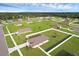 A quiet neighborhood is seen from above, with homes neatly placed on green lawns in an open space area at 12835 Del Lago Dr, Astatula, FL 34705