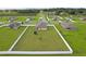 Aerial view of a home with a spacious, fenced yard in a quiet neighborhood, perfect for Gathering living at 12835 Del Lago Dr, Astatula, FL 34705