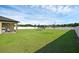 Expansive backyard with green grass and trampoline, perfect for outdoor activities at 12835 Del Lago Dr, Astatula, FL 34705
