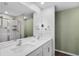 Modern bathroom featuring double sinks, a shower, and stylish vanity lighting at 12835 Del Lago Dr, Astatula, FL 34705
