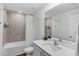 Bright bathroom features a shower-tub combo with tiled walls and modern vanity at 12835 Del Lago Dr, Astatula, FL 34705