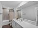 Modern bathroom featuring a tub shower combo, white vanity and quartz countertops at 12835 Del Lago Dr, Astatula, FL 34705